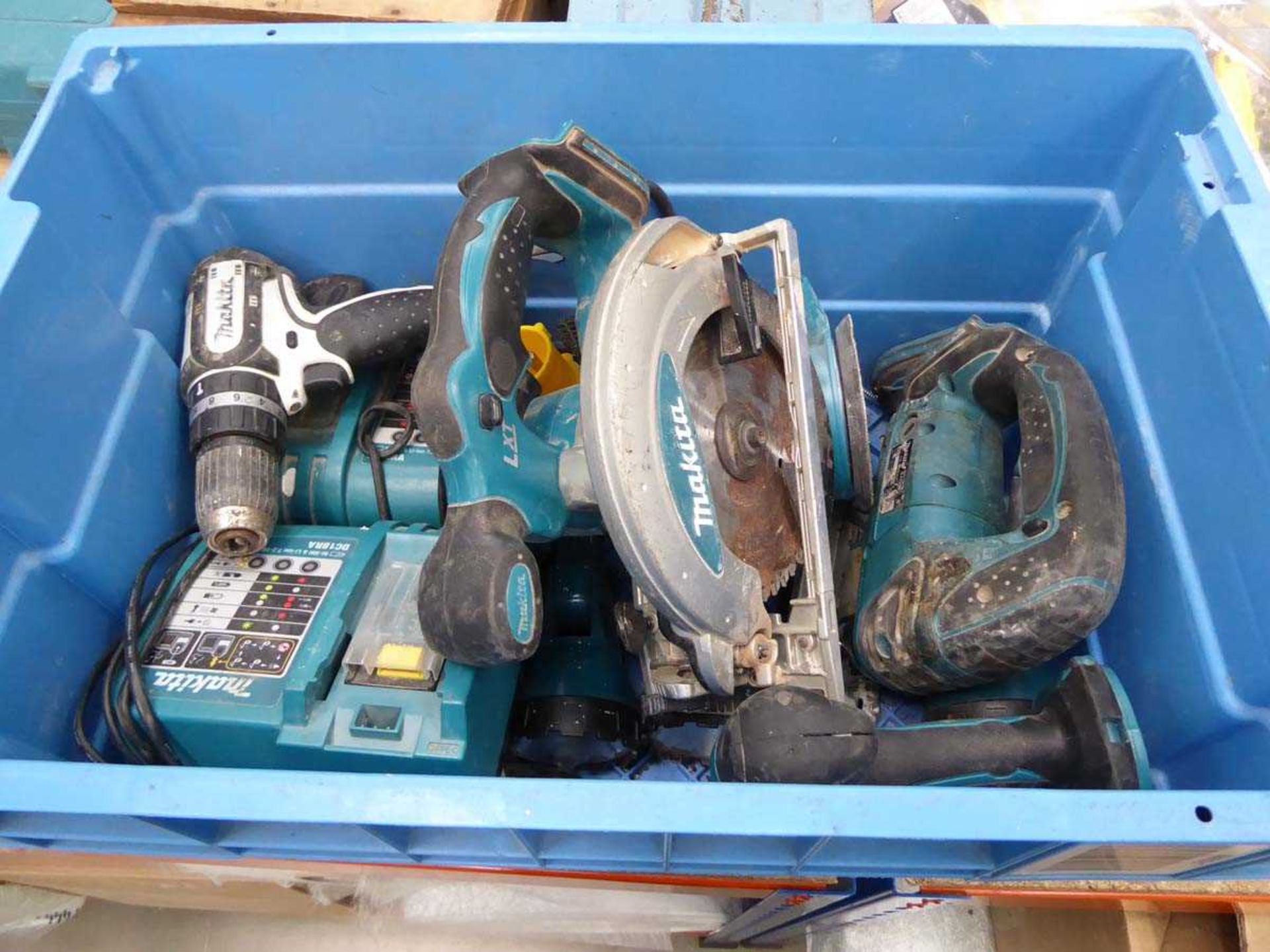 Box of Makita tools including drill, circular saw, chargers, sanders, no batteries, one charger