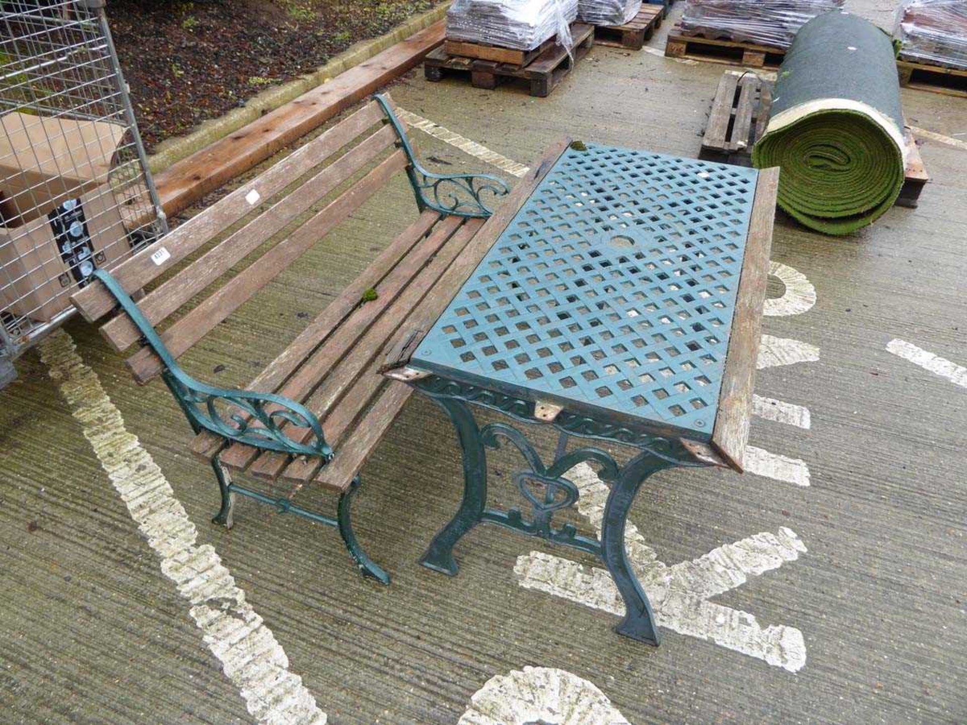 Wooden and metal framed garden bench and a table Table in need of repair