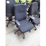 Black cloth swivel armchair