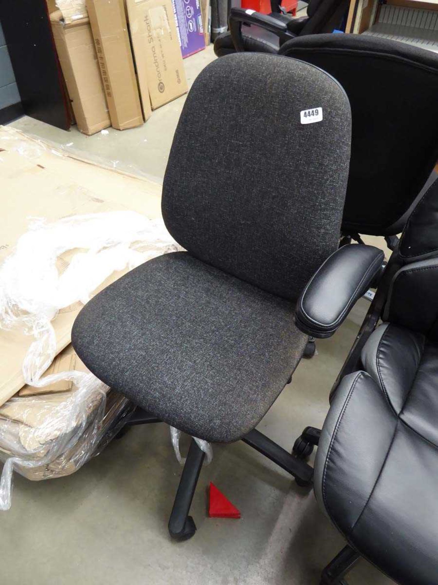 Black cloth swivel chair on black base