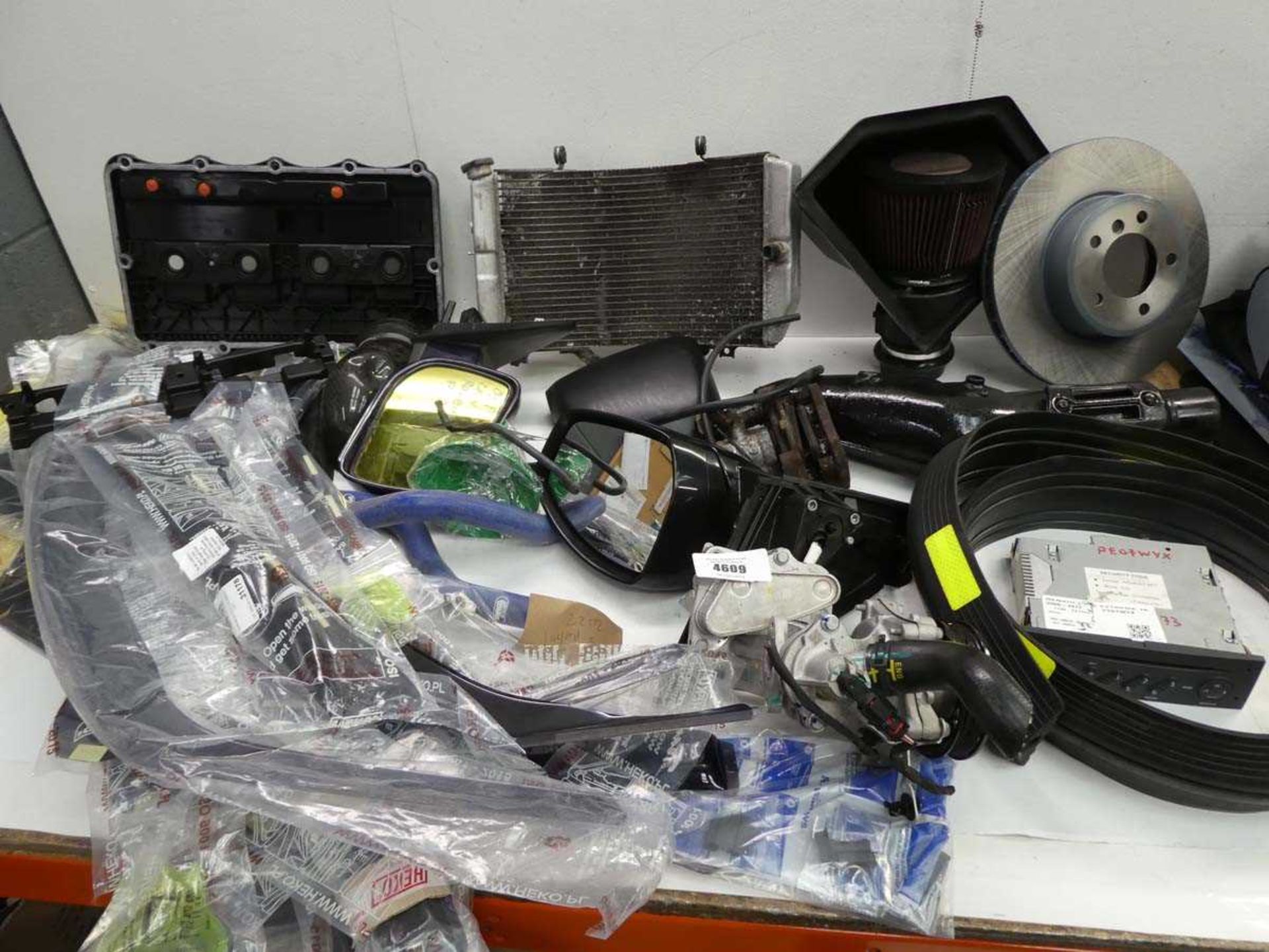 +VAT Large box containing car spare parts including radiator, wing mirrors, engine cooler, brake