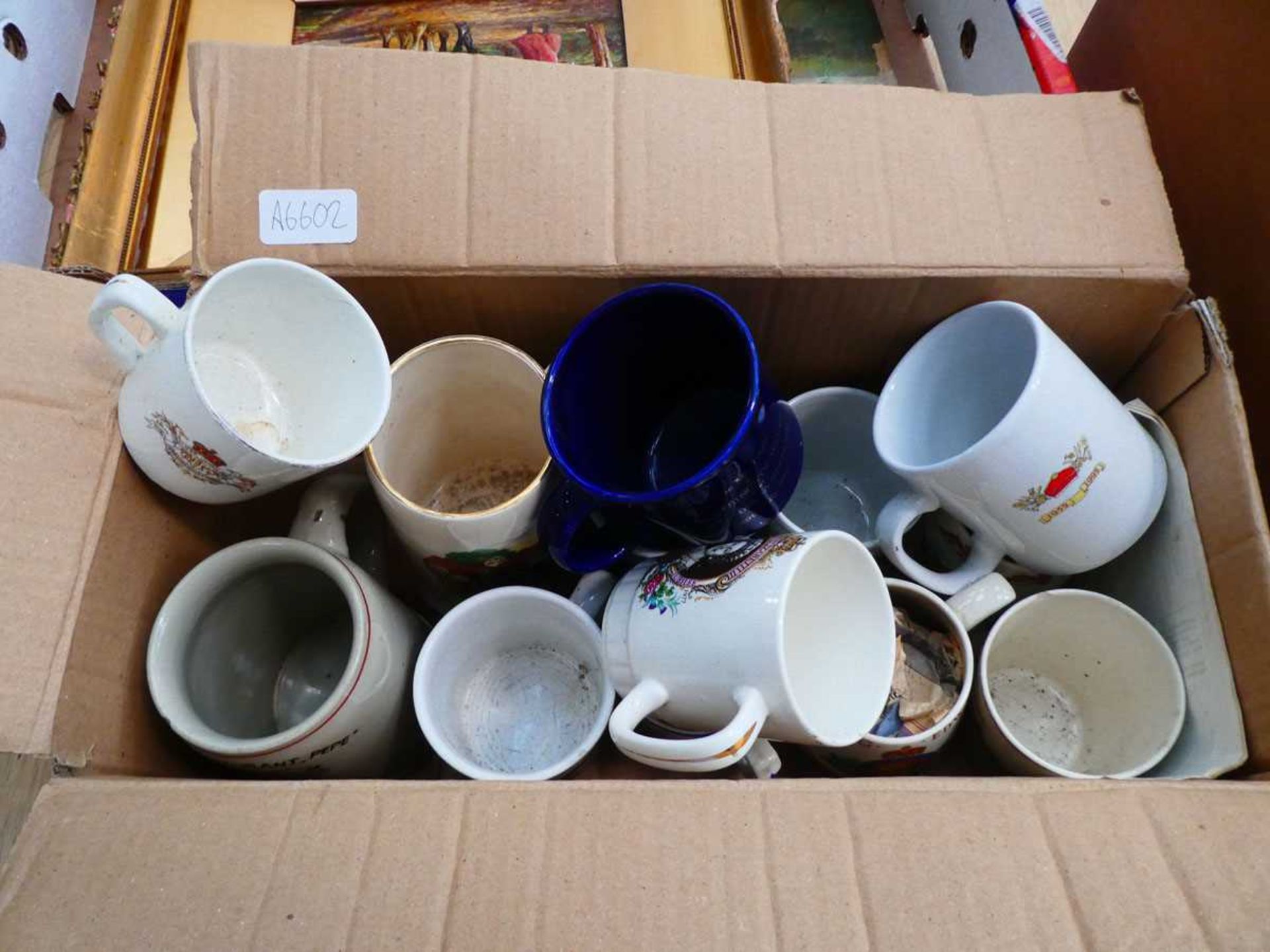 Box containing commemorative and other coffee mugs