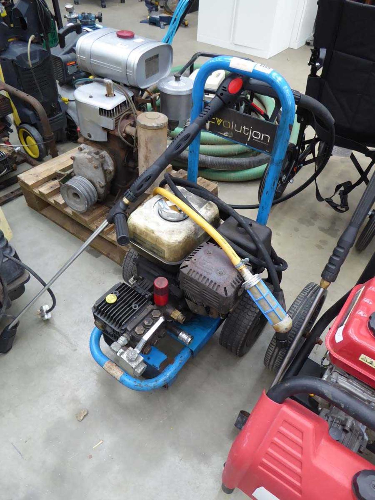 Blue petrol powered pressure washer with hose and lance