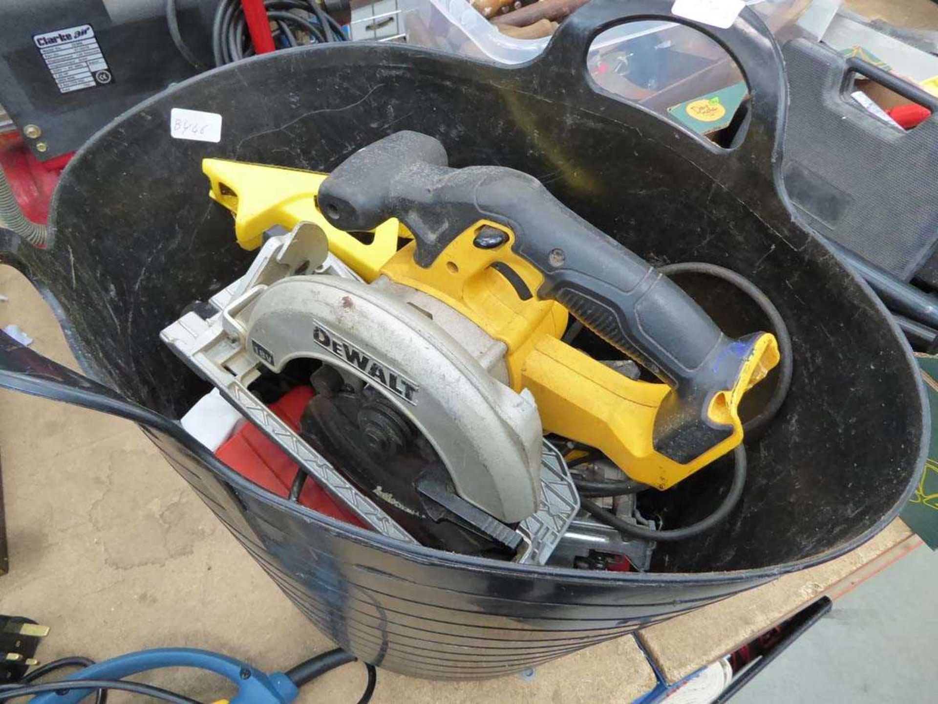 Plastic bucket containing Dewalt circular saw, charger (no batteries), jigsaw, etc.