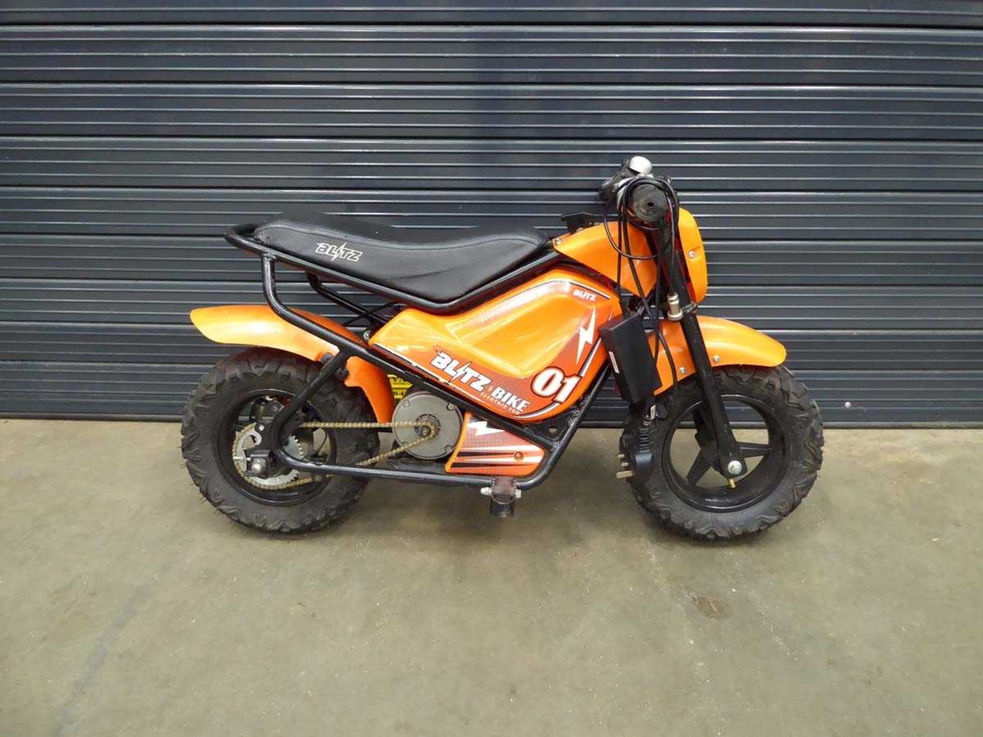 Small Blitz orange electric child's motorbike with charger