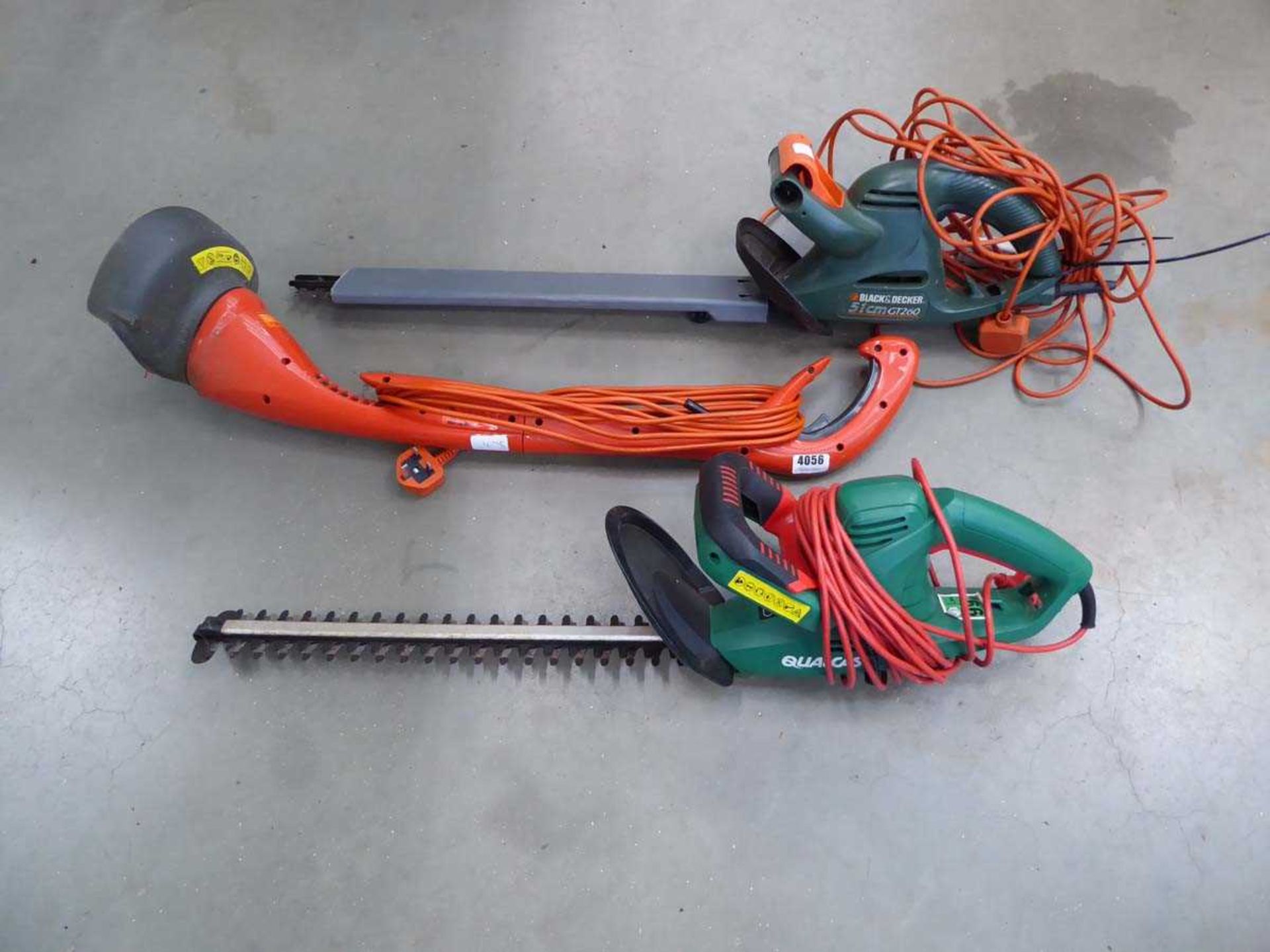 2 green electric hedgecutters and an orange Flmyo electric strimmer