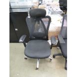 Black cloth mesh backed swivel armchair with chrome frame and headrest