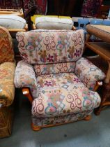 Beech armchair with floral patterned cushions