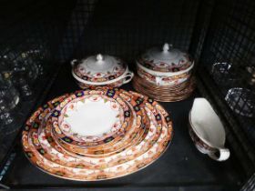 Cage containing floral patterned Edwardian crockery