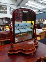 A Victorian mahogany swing mirror with two turned columns and a storage compartment, h. 80 cm