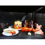 Cage containing carved african and chinese figures, Wade piggy bank, biscuit barrel, and