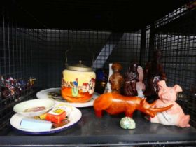 Cage containing carved african and chinese figures, Wade piggy bank, biscuit barrel, and