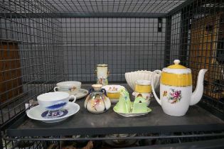 Cage containing 3 piece cruet set, cups and saucers, shell shaped bowl, plus teapot and vase