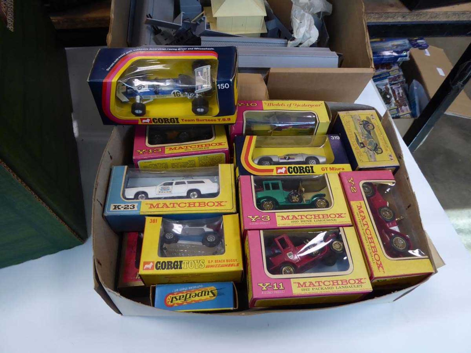 Box containing toy cars and railway set