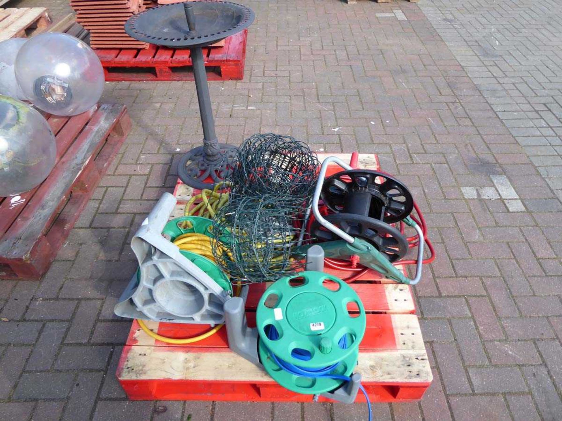 Pallet containing plastic bird bath, hose pipe reels and mesh