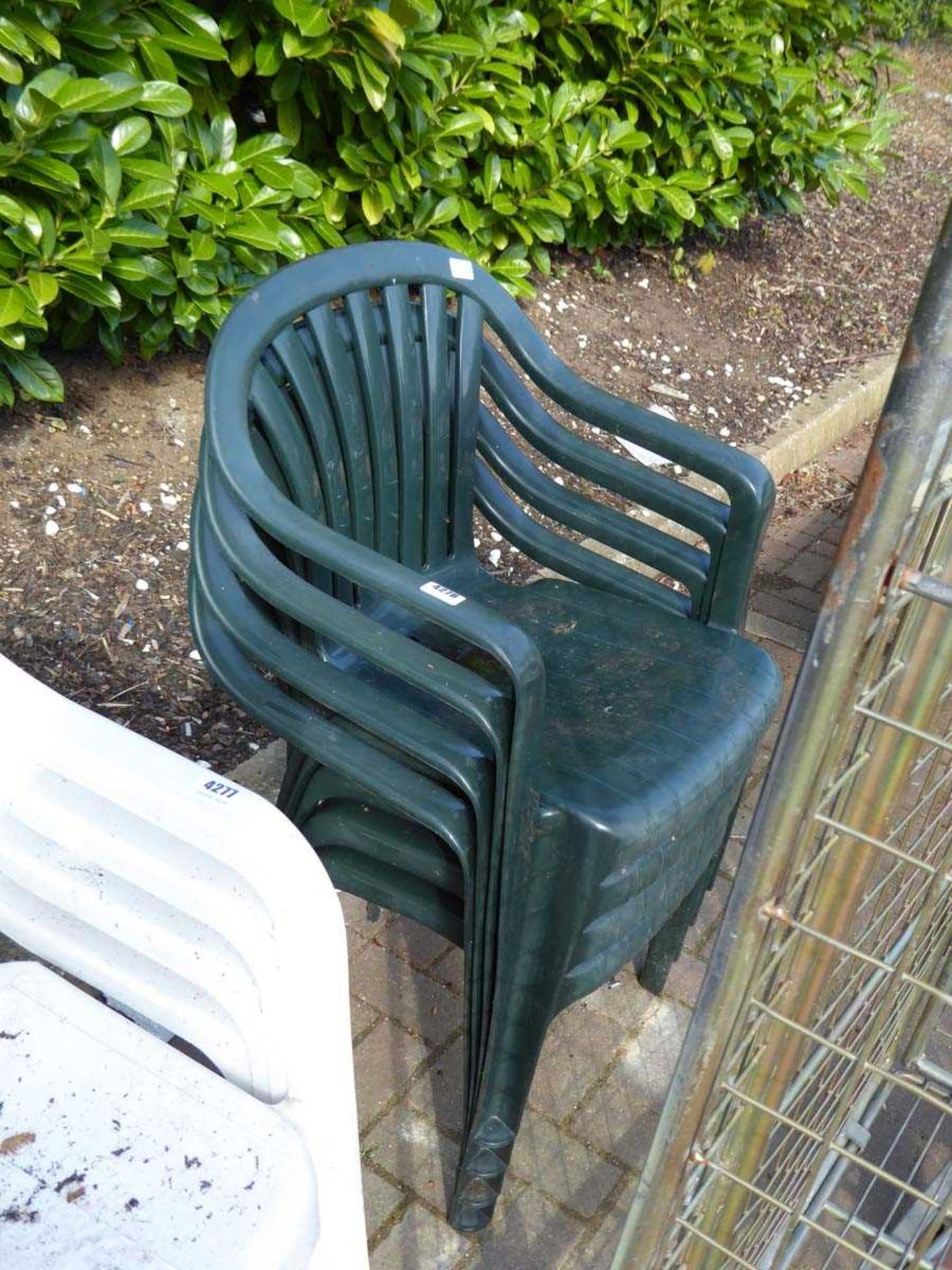 4 green plastic stacking chairs