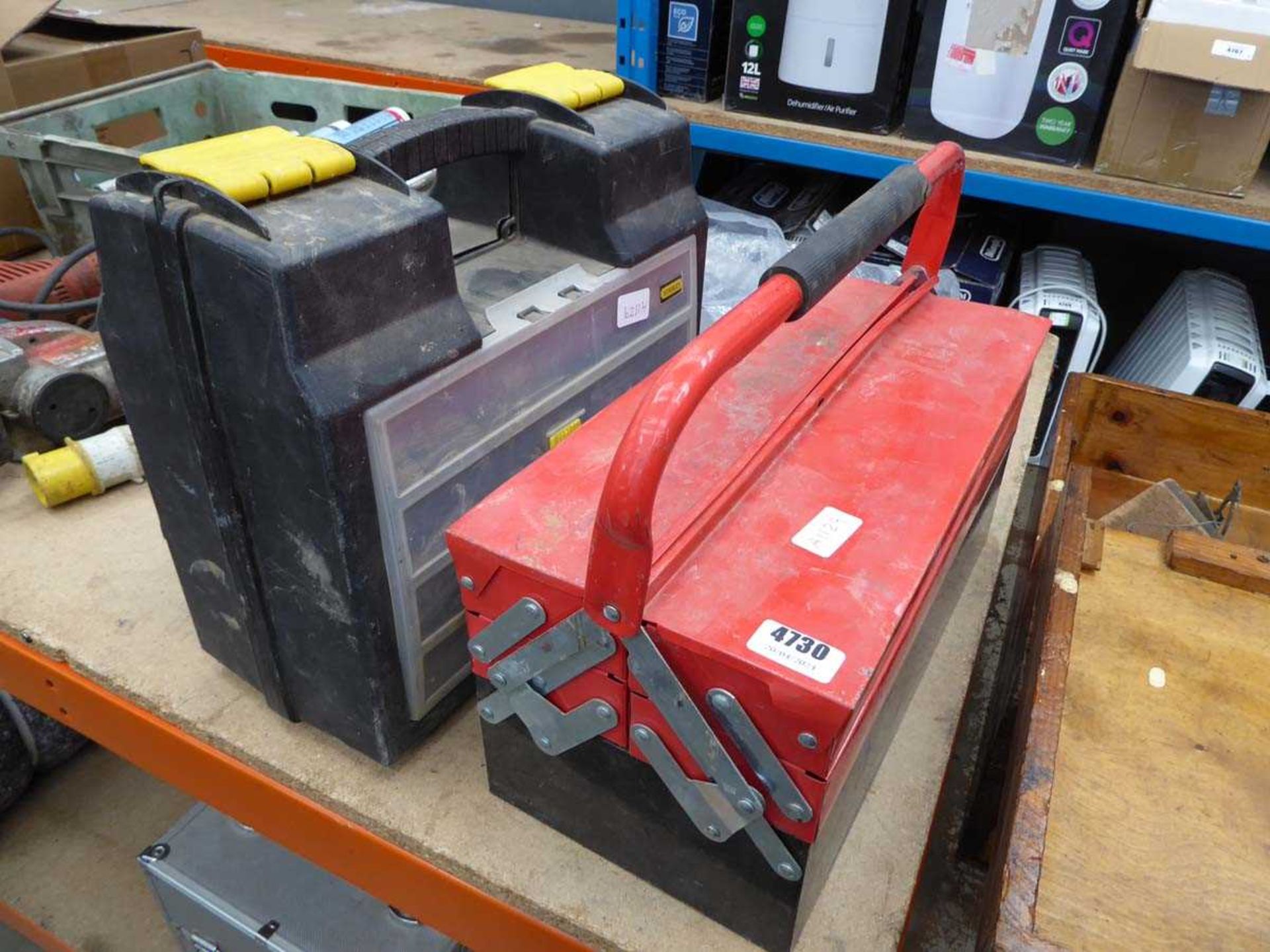 Red cantilever toolbox, and plastic toolbox of various tools and fixings