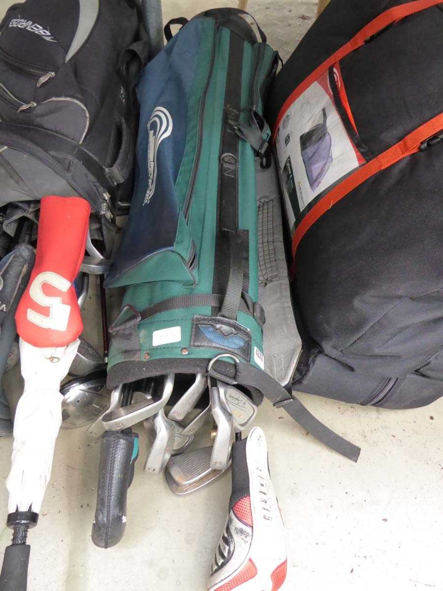 Green golf bag with assortment of clubs