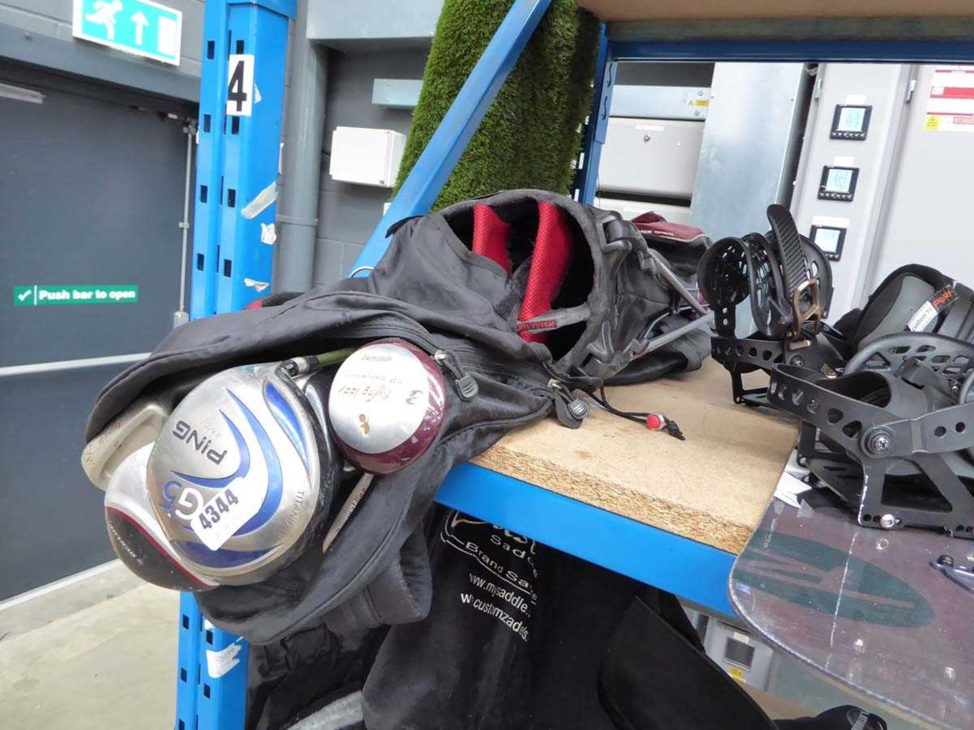 Red and black golf bag with assorted clubs