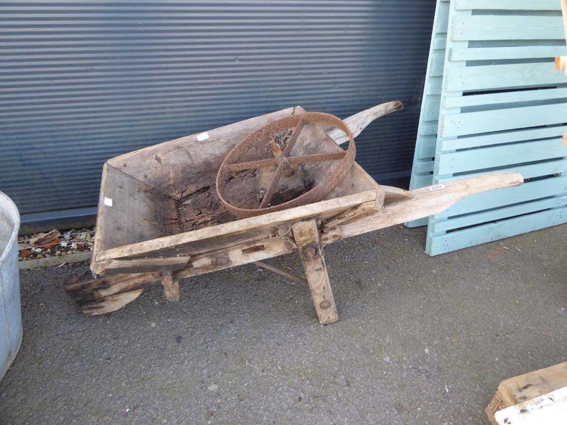 Wooden wheelbarrow In need of repair