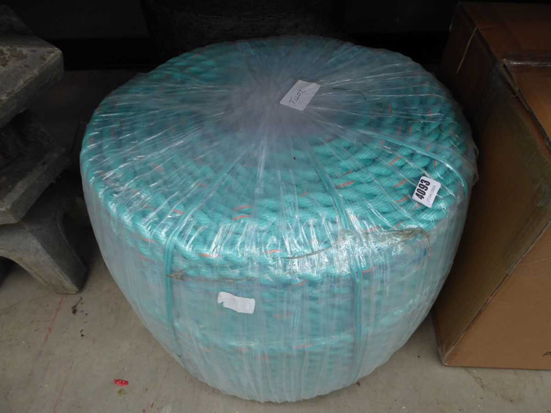 Large roll of rope and roll of material
