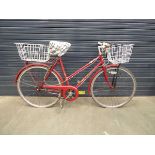 Red lady's bike with front and back basket
