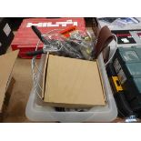 Plastic box of drain snake, sanding belts and various other tools