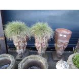 3 terracotta planters in the form of heads - 2 with grass