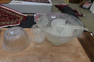 Moulted glass punch bowl with ladle, cups and fruit bowl