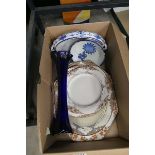 Cage containing blue and white and orange grove patterned crockery plus blue glass vase
