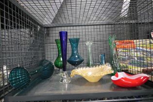 Cage containing coloured glass vases and dishes
