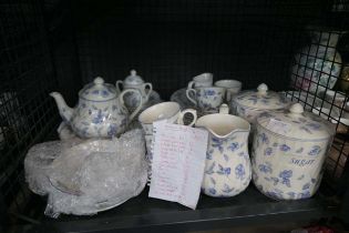Cage containing Bristol Blue floral patterned crockery