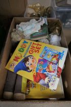 Box containing board games and dolls