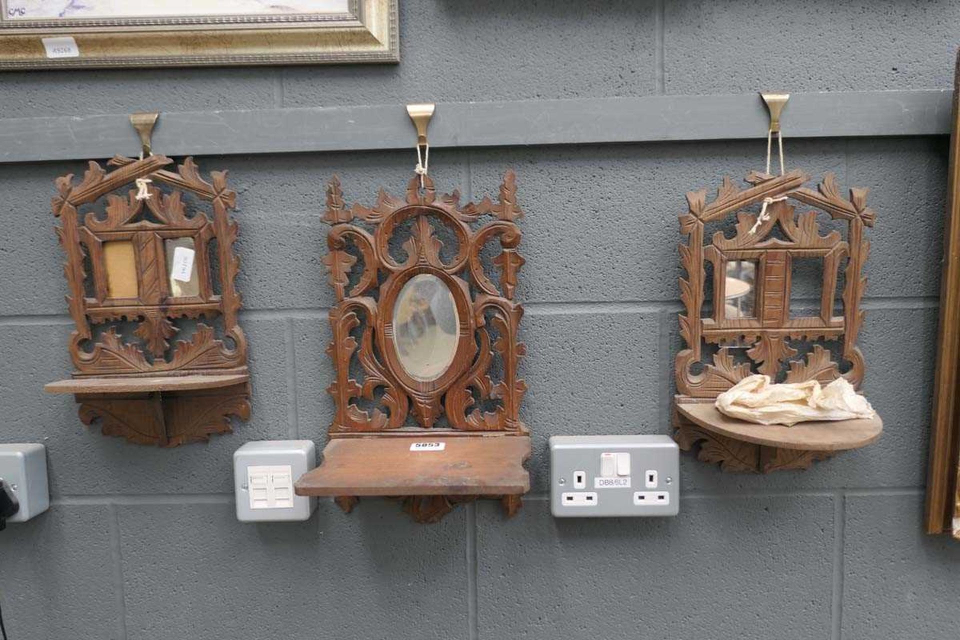 Three fretwork hanging shelves with mirrors