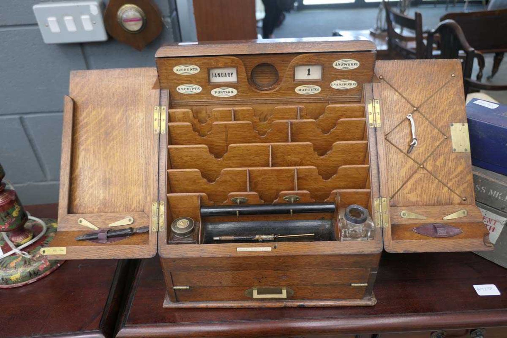 Oak letter rack with writing slope under made by Parkins and Gotto, Oxford Street, London