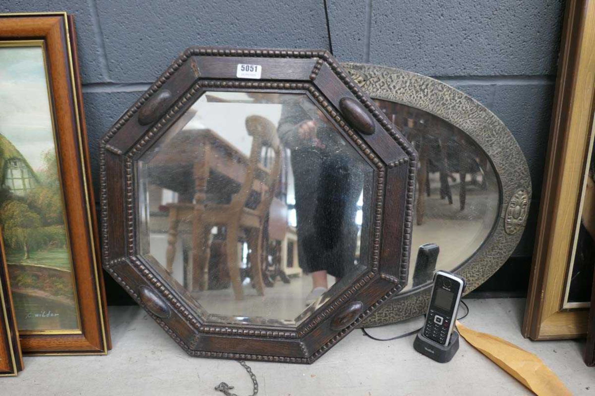 Two metal and oak framed bevelled mirrors