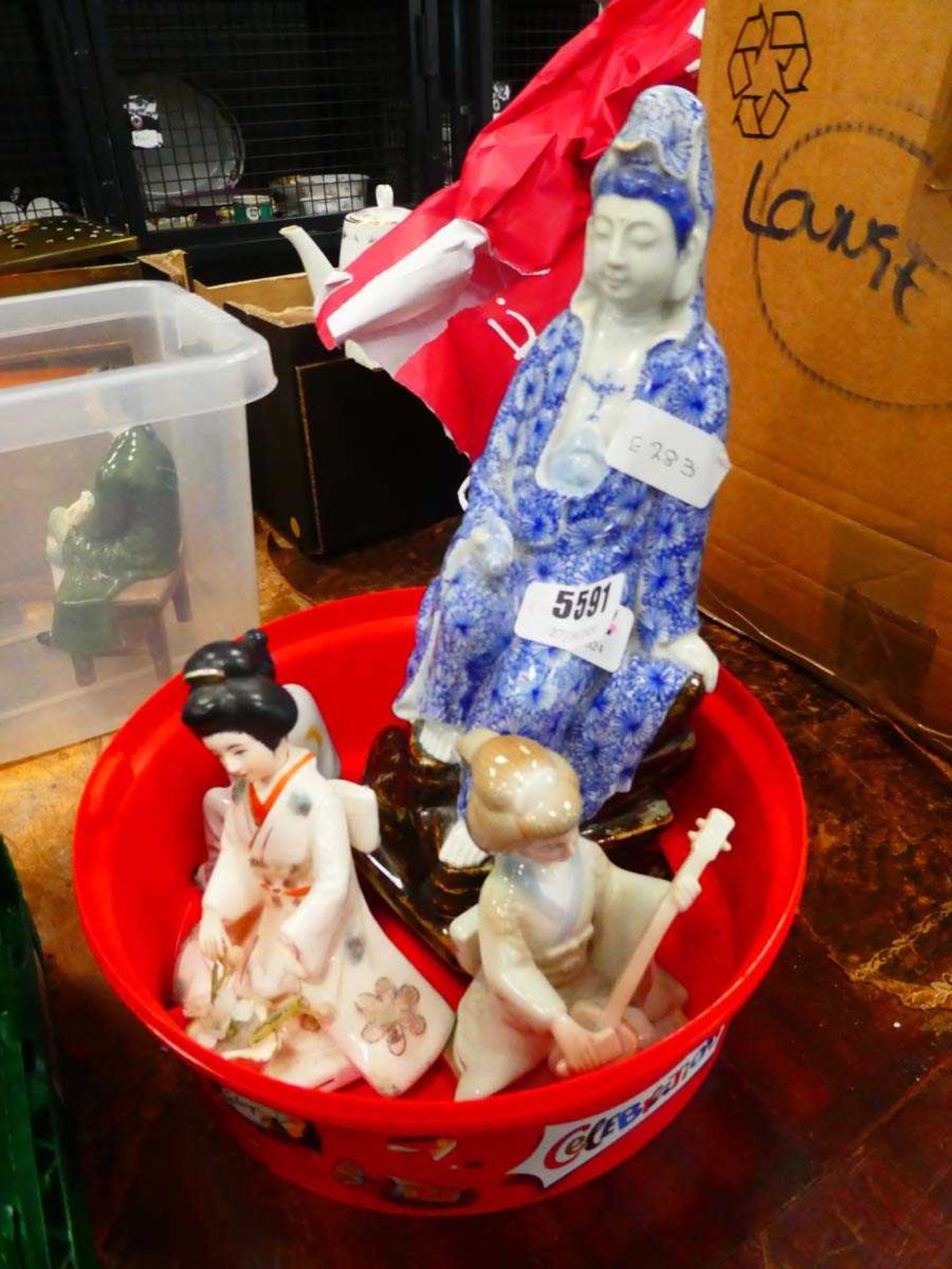 Four ceramic Chinese figures The Guanyin statue is in generally good condition with no chips or
