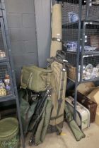 Large quantity of fishing tackle to include spinning reels and boxes plus a seat, bivvy, landing net