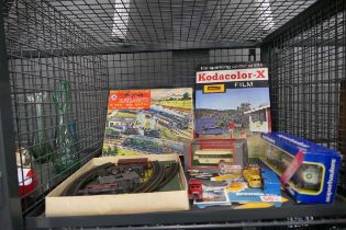 Cage containing rolling stock plus boxed Diecast vehicles and a Kodak advertising poster