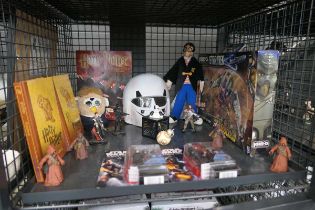Cage containing Star Wars and Harry Potter related figures and books