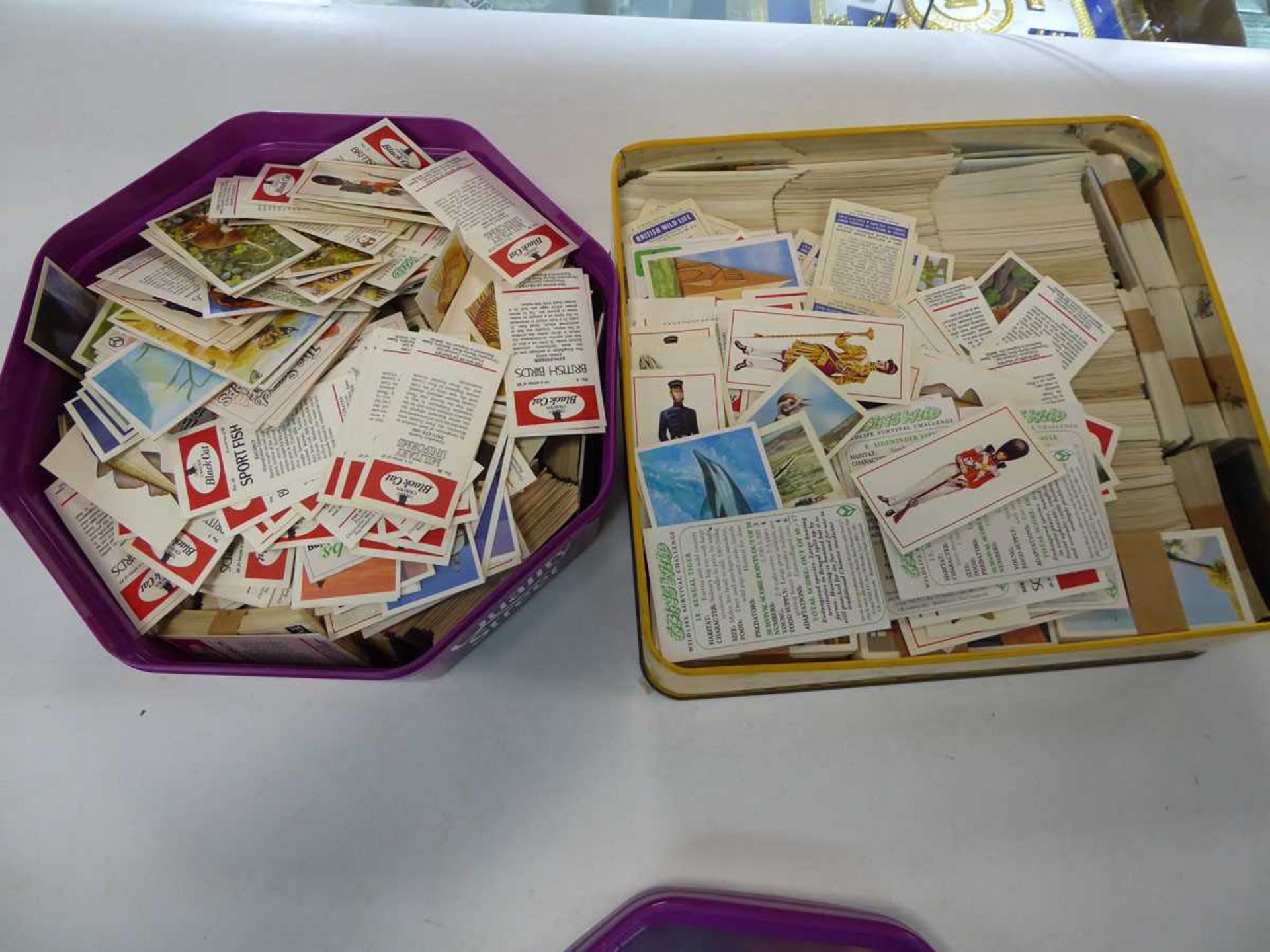 2 boxes containing cigarette cards