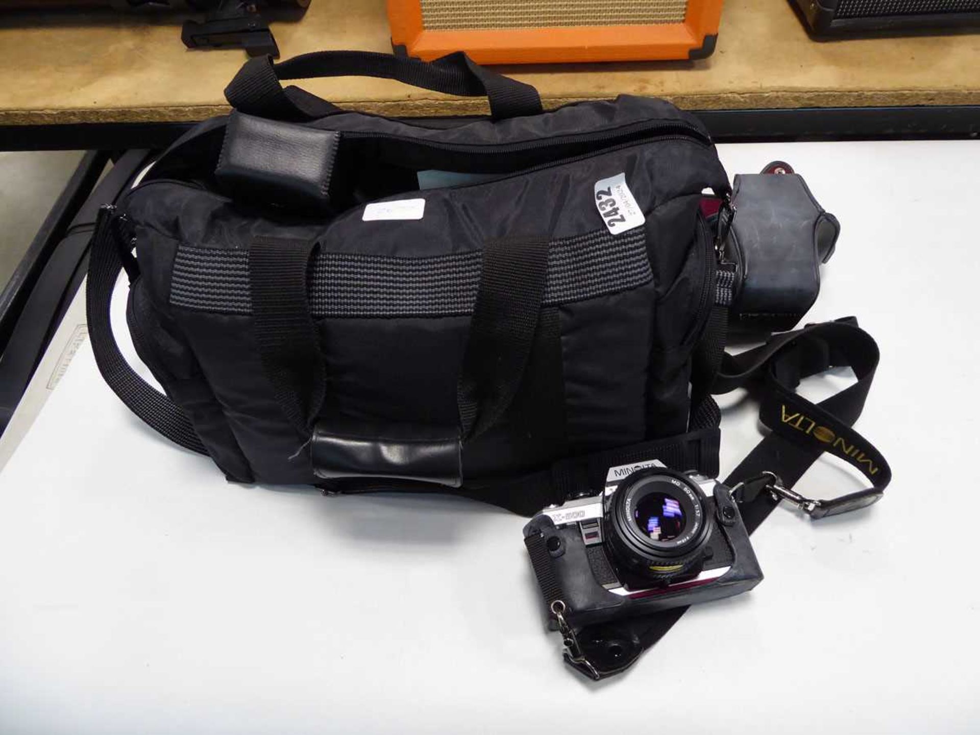 Minolta X500 camera with accessories and camera bag