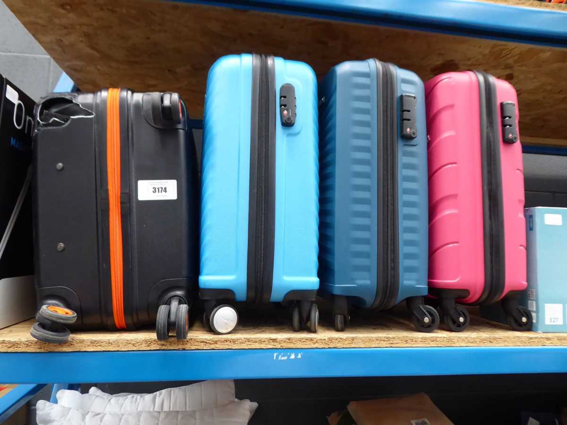 +VAT Medium hard shelled suitcase plus three mini ones