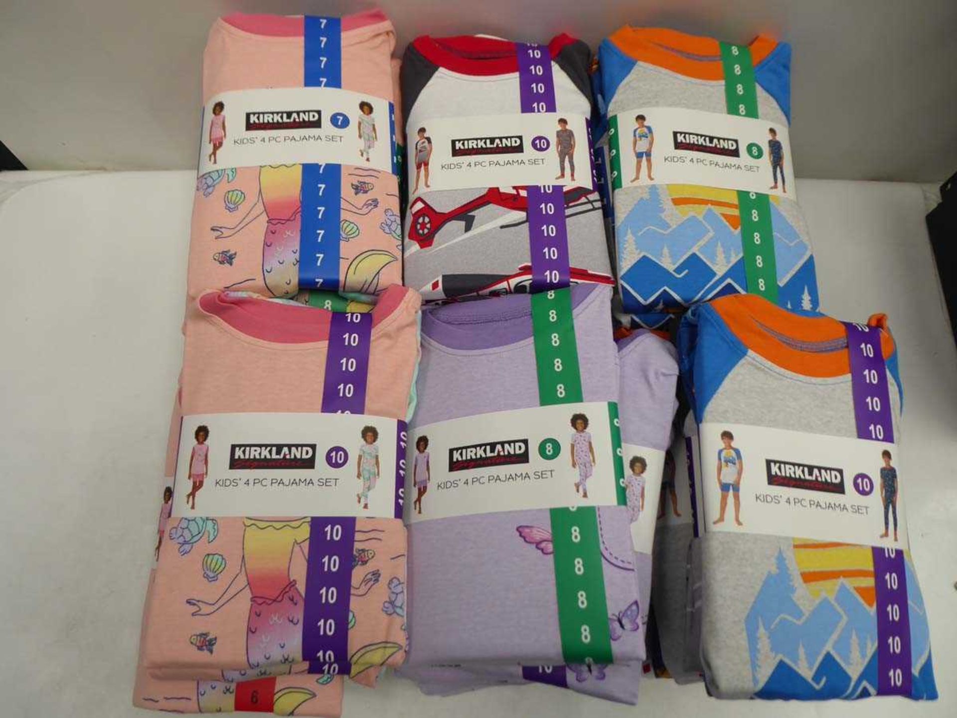 Approx. 30 Kirkland SIgnature kids 4 piece pyjama sets in various colours, sizes, and genders