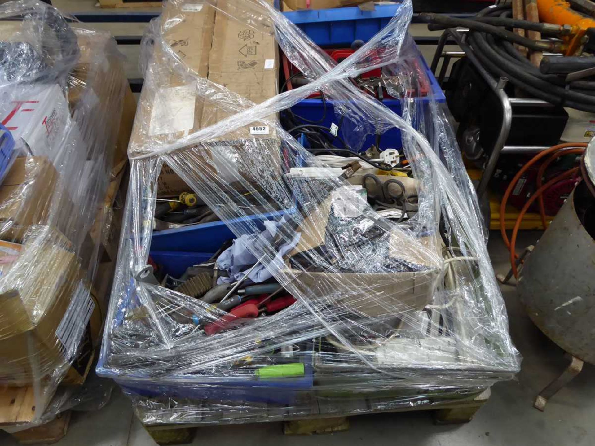Pallet of assorted items including tools, extension cables, transformer, etc