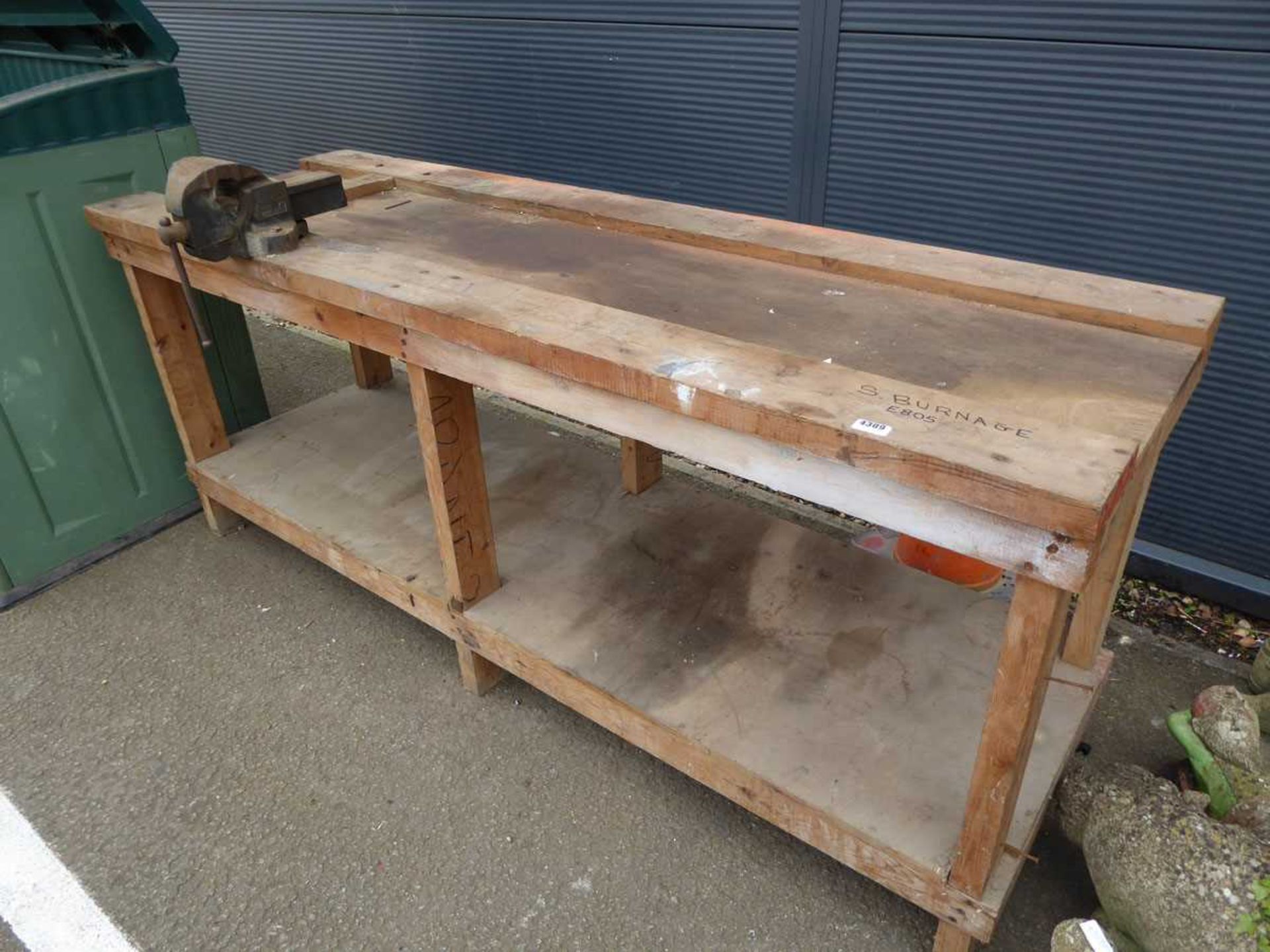 Large wooden work bench with metal vice