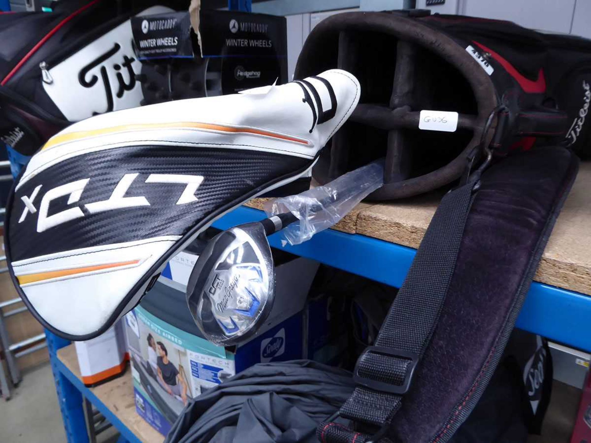 Titleist golf bag and a McGregor and Cobra clubs