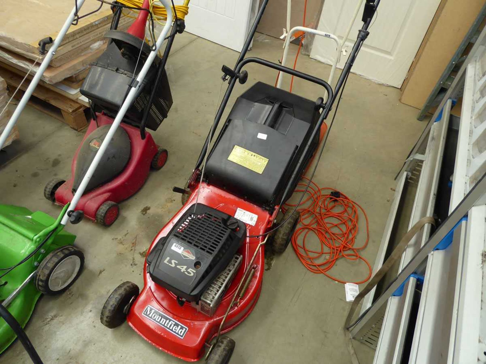 Red Mountfield petrol powered rotary mower with grass box