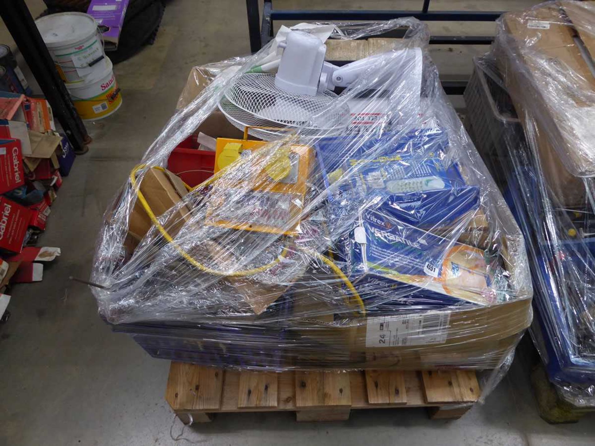 Pallet of assorted items including tile cutters, door locks, fans, transformer boxes, etc