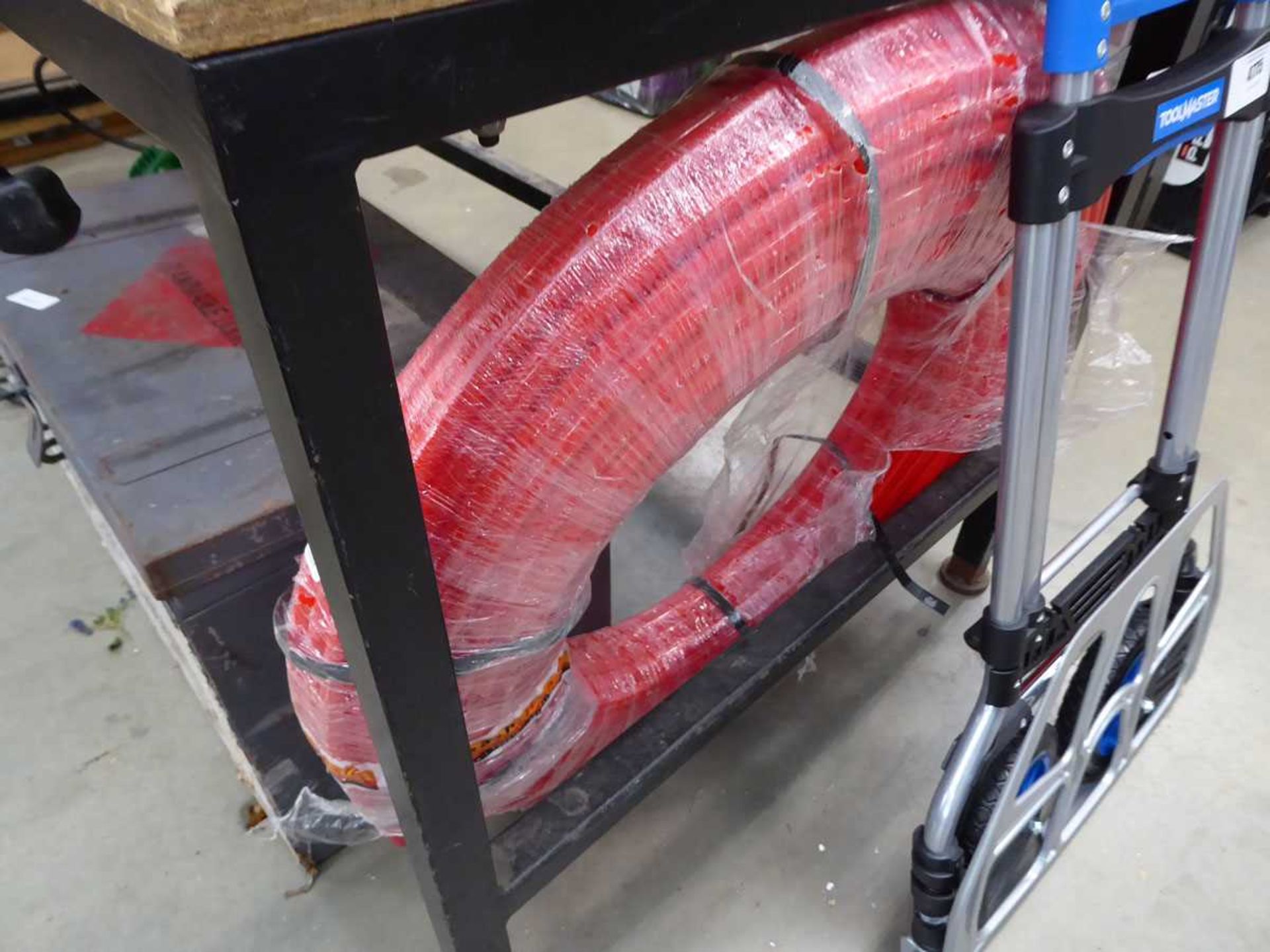 Roll of red plastic hose